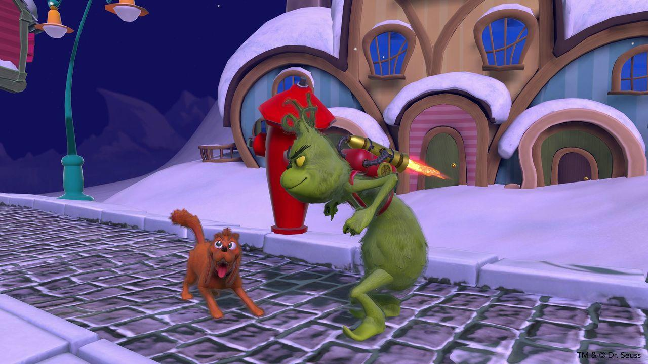 Der Grinch mit Jetpack steht dem Hund in einem verschneiten Dorf mit bunten Häusern und einem roten Hydranten gegenüber.