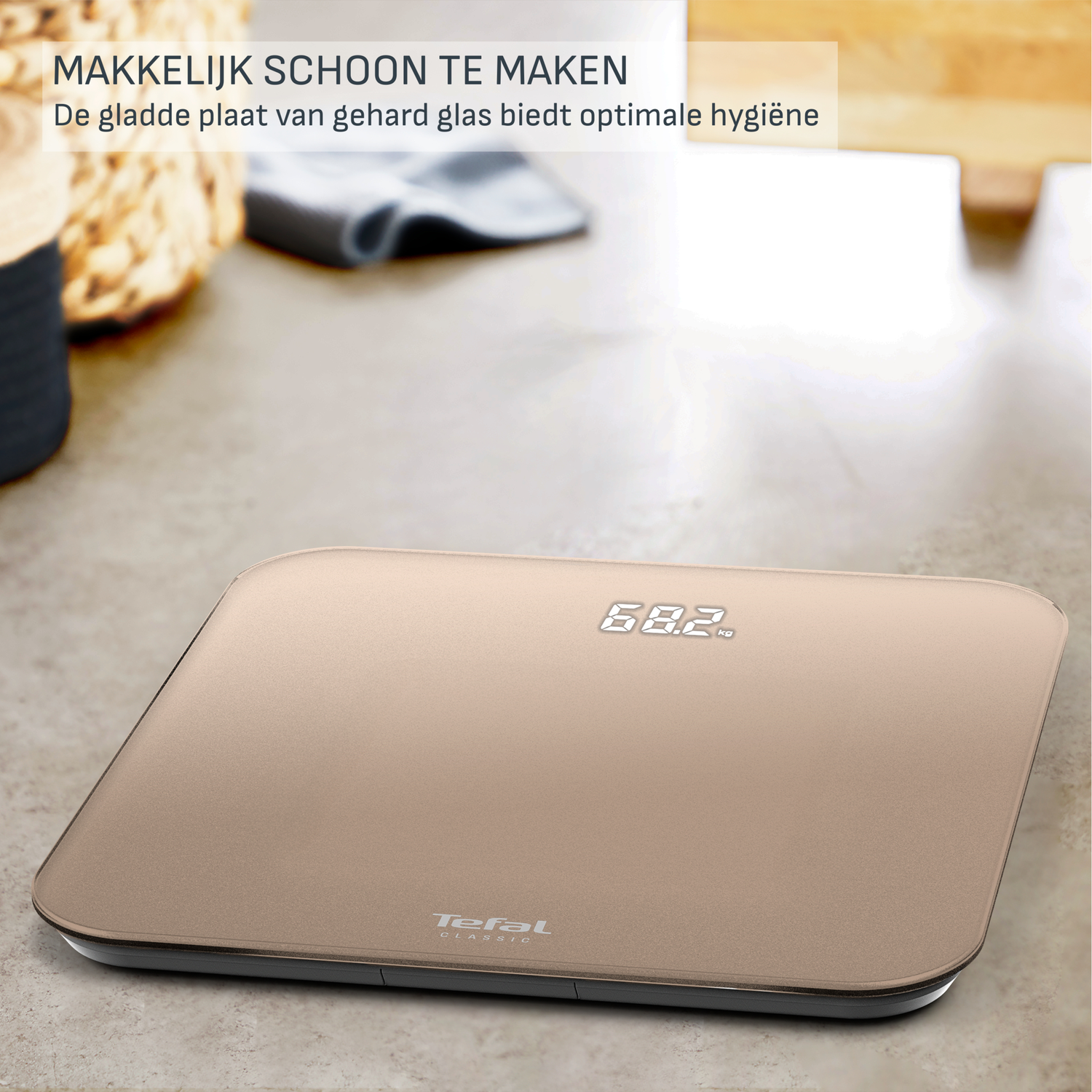 A digital kitchen scale displays 68.2 kg. It's gold-colored with a black border, and the brand 'Tefal' is visible.