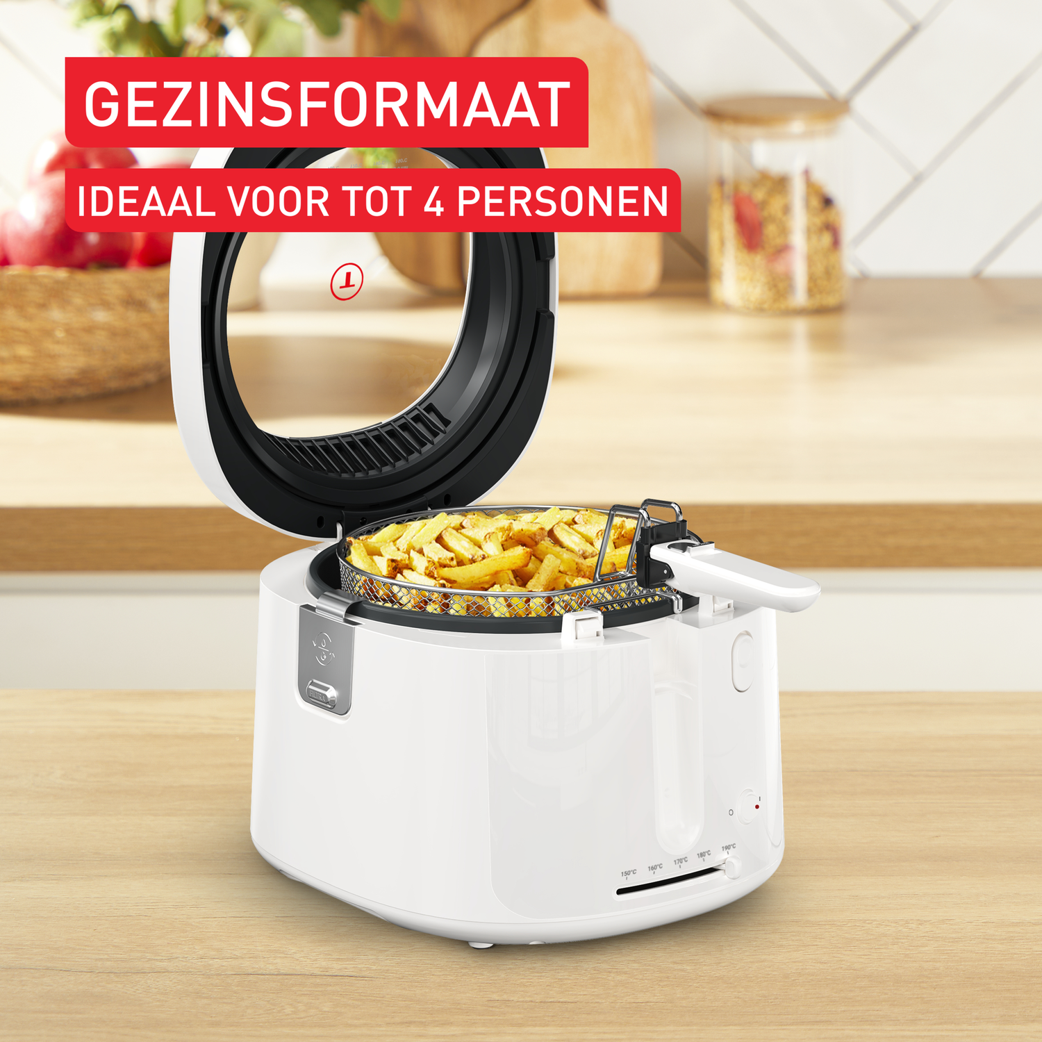 A white air fryer with fries inside, lid open. Text reads 'Family size, ideal for 4 persons'. Background: wooden surface, apples, and jars.