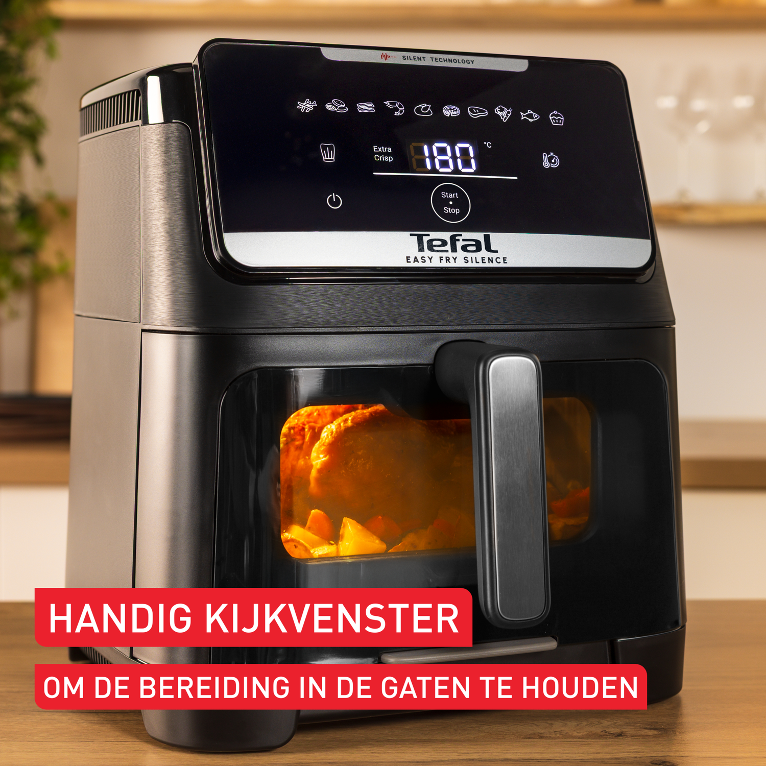 Black Tefal air fryer with a digital display showing 180°C. A window shows cooking food. Text says 'Handig Kijkvenster'.