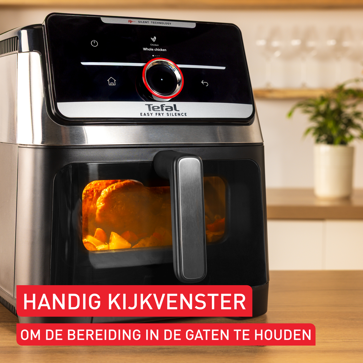 An air fryer with a digital display shows a whole chicken. The appliance is black and silver, with food inside.