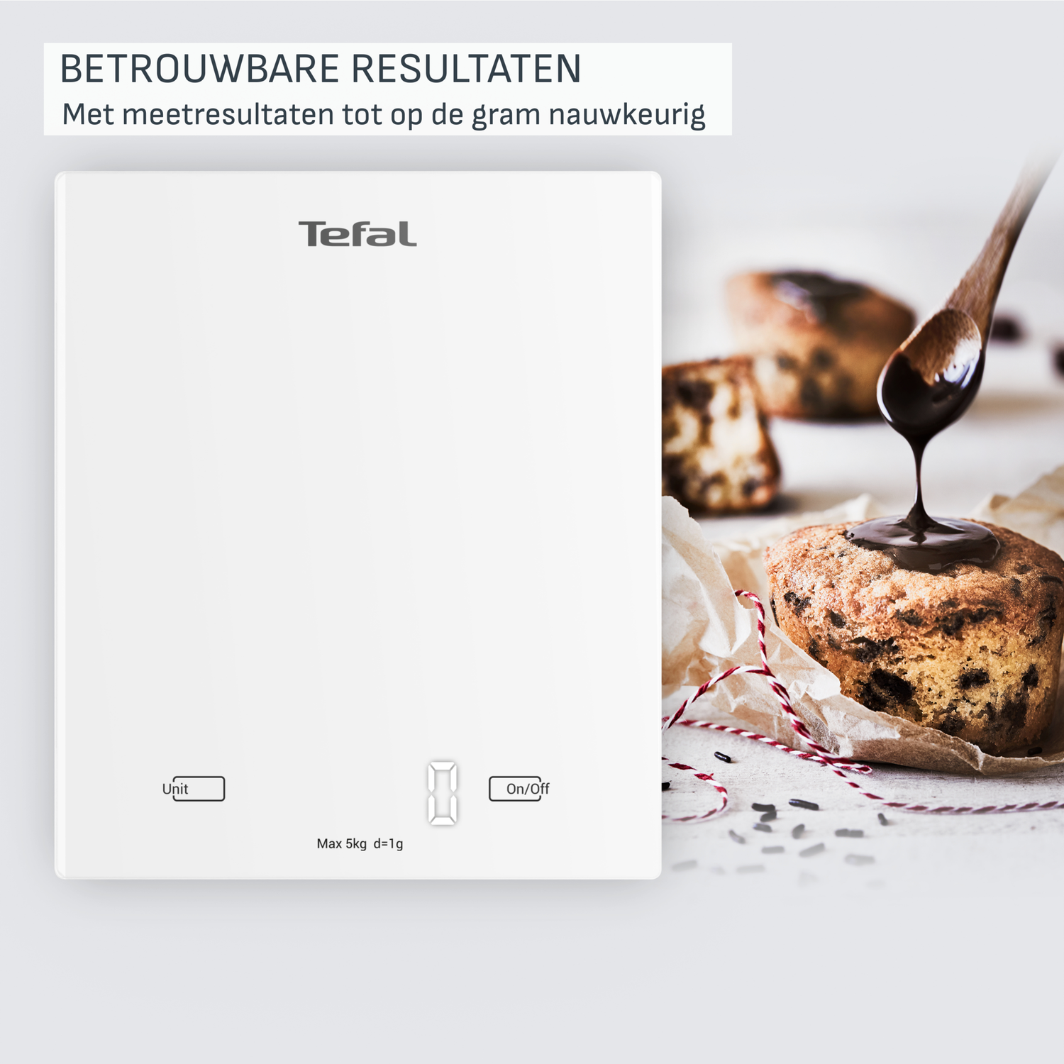 A white Tefal scale with digital display, next to a muffin being drizzled with chocolate sauce from a wooden spoon.