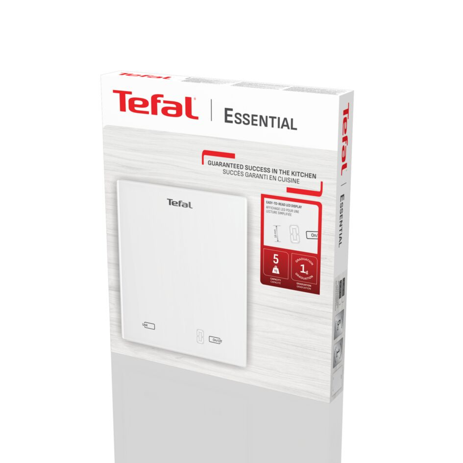 A white Tefal Essential kitchen scale box. It has the Tefal logo, product details, and specifications like capacity and graduation.