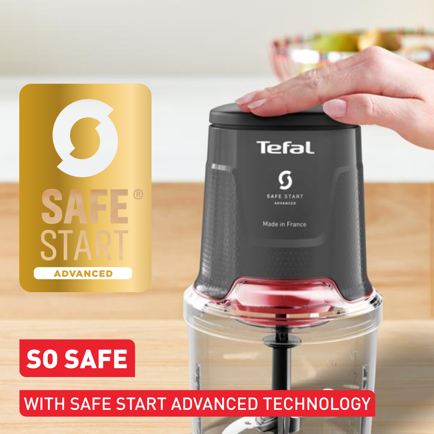 A Tefal food chopper with a hand on top, a safety logo, and text that says 'SO SAFE' and 'SAFE START ADVANCED TECHNOLOGY'.