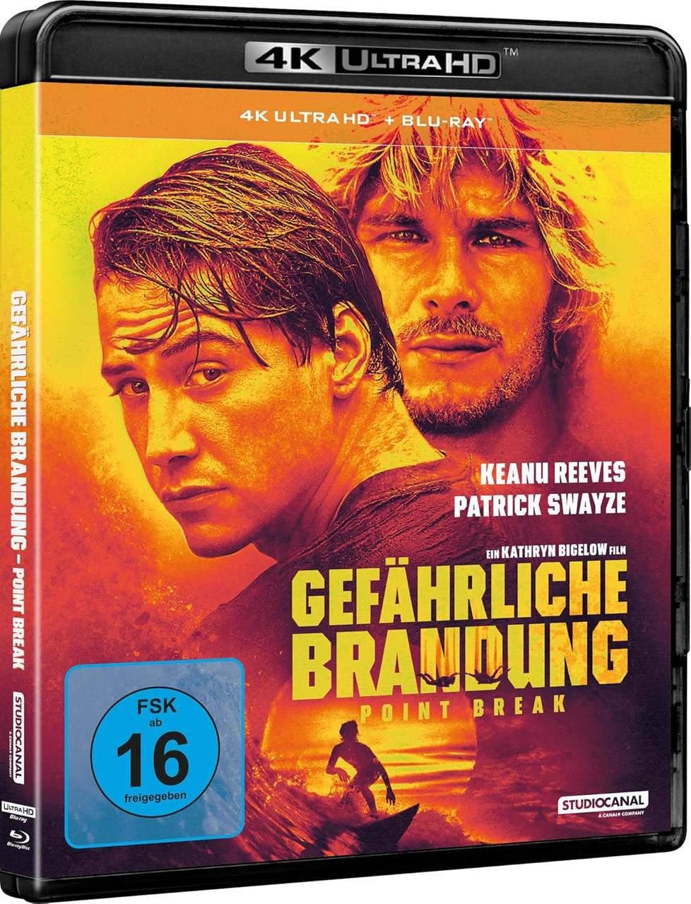 Filmcover von Point Break. Zeigt Keanu Reeves und Patrick Swayze. Titel auf Deutsch: Gefährliche Brandung. Mit Surfer-Silhouette.