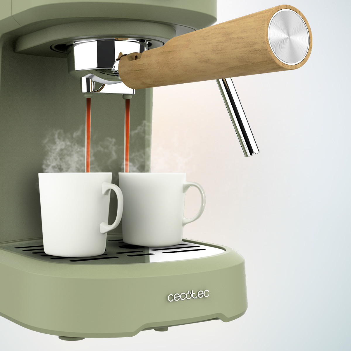 Máquina de espresso con dos tazas blancas. El café fluye hacia las tazas. La máquina es verde con mango de madera.