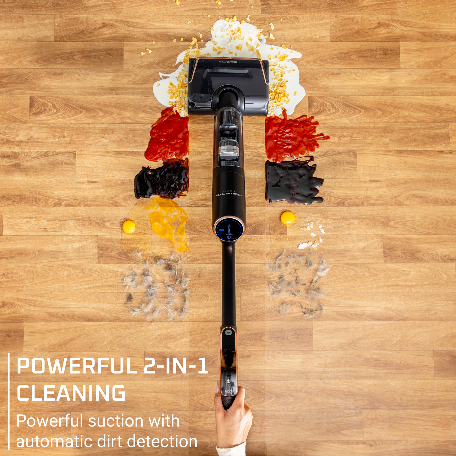 A vacuum cleaner cleans spills on wooden floor. Spills of milk, ketchup, and other substances are visible. Text states powerful cleaning.