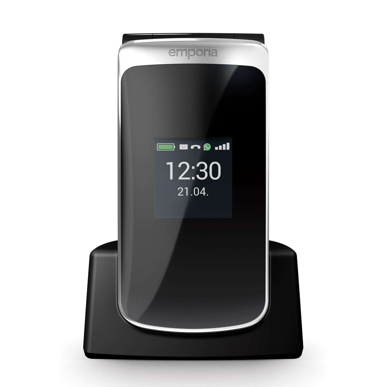 Un telefono Emporia in bianco e nero è in una base di ricarica. Lo schermo mostra l'ora 12:30 e la data 21.04. Il telefono è acceso.
