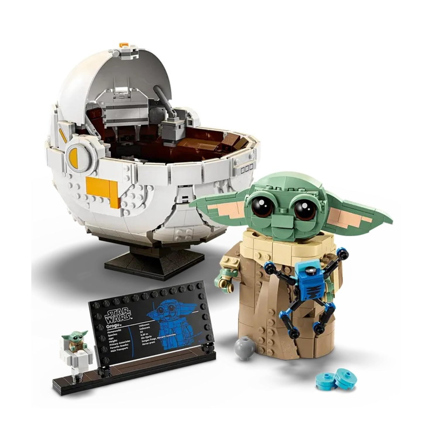 Un set Lego Star Wars con Grogu, il suo pod e un piccolo robot. Il set include un espositore con i dettagli di Grogu.