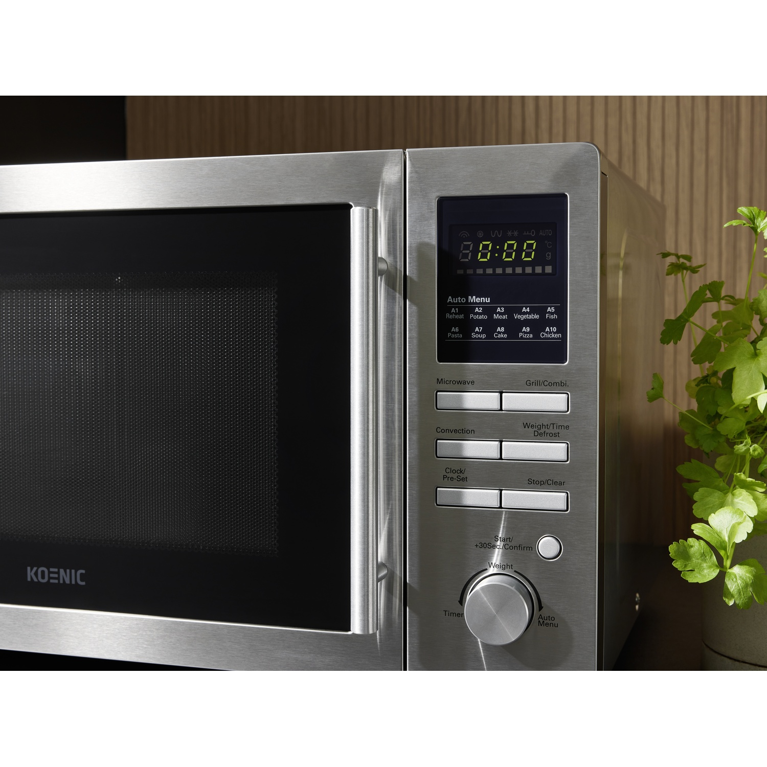 Un forno a microonde in acciaio inossidabile con display digitale 88:88. Pulsanti: menu automatico, timer e avvio. Una pianta sullo sfondo.