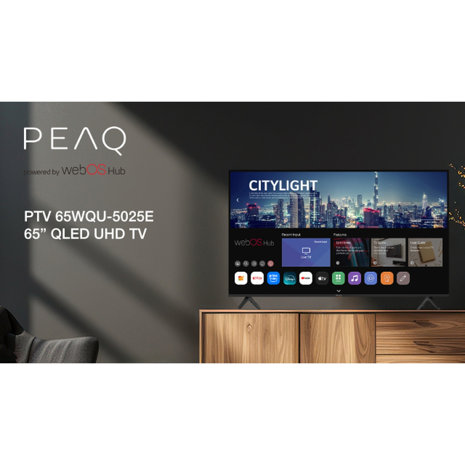 Un televisore mostra una scena cittadina. Il televisore è su un mobile di legno. Il logo del marchio è in alto a sinistra. Testo: PTV 65WQU-5025E 65" QLED UHD TV.