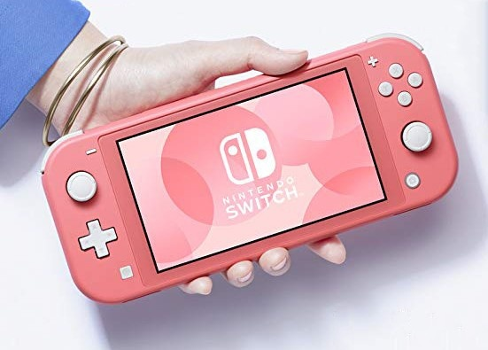 Dłoń trzyma koralowy Nintendo Switch Lite. Ekran wyświetla różowe tło z logo Nintendo Switch.