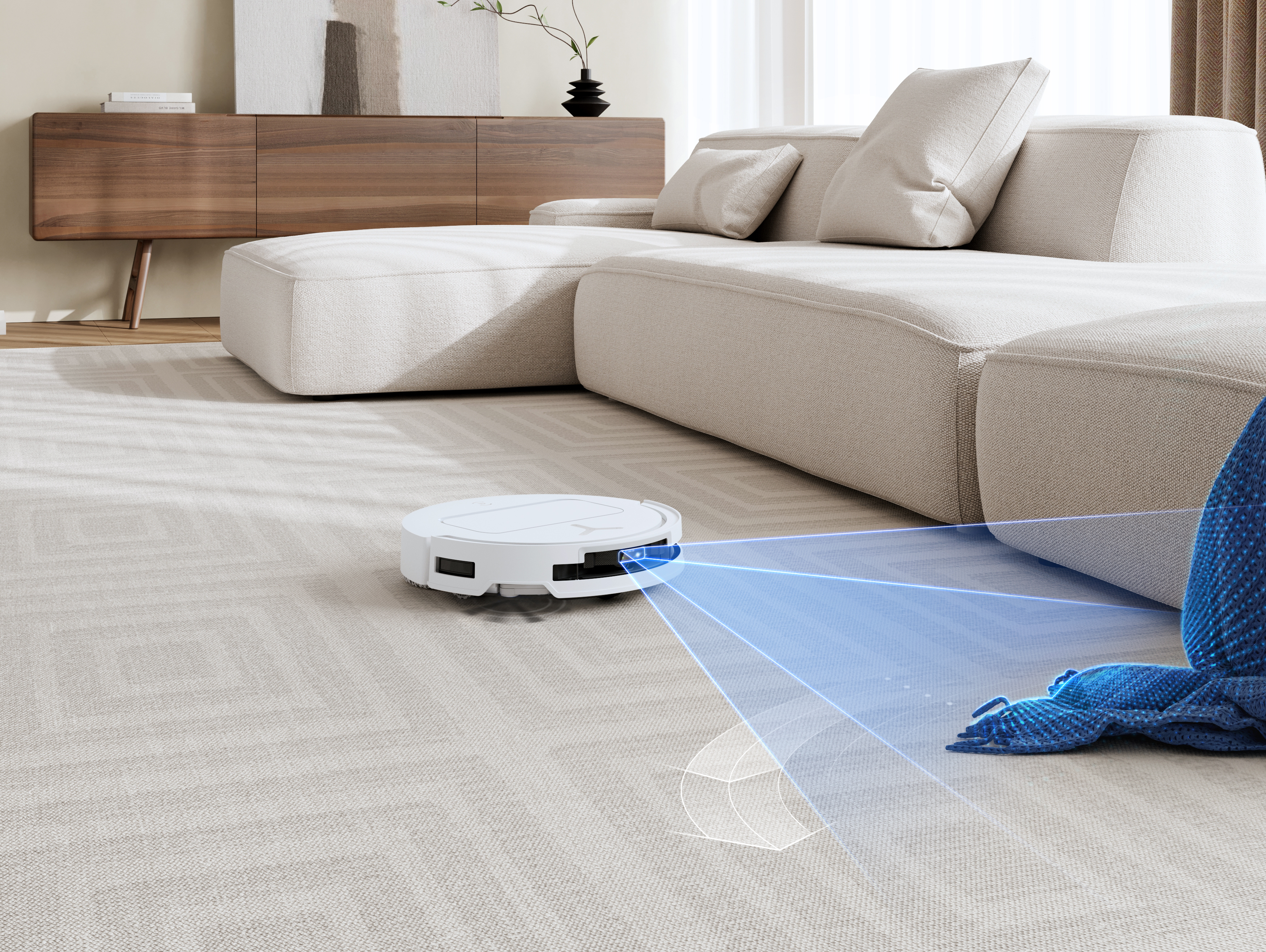 Biały odkurzacz robot na wzorzystym dywanie, z sofą i meblami w tle.