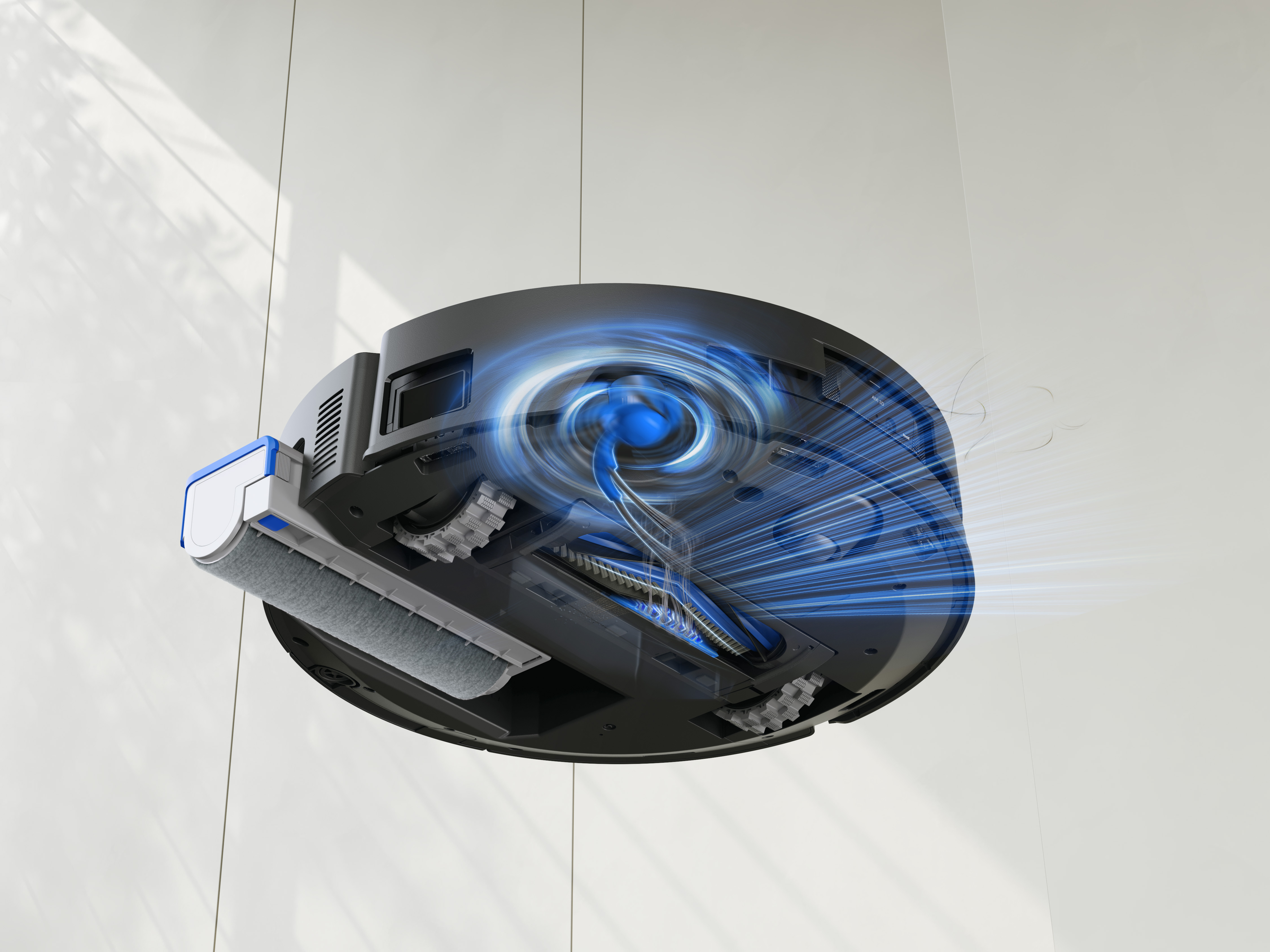 Robot odkurzający z niebieskimi liniami energii, szarym wałkiem i białym tłem ściany.