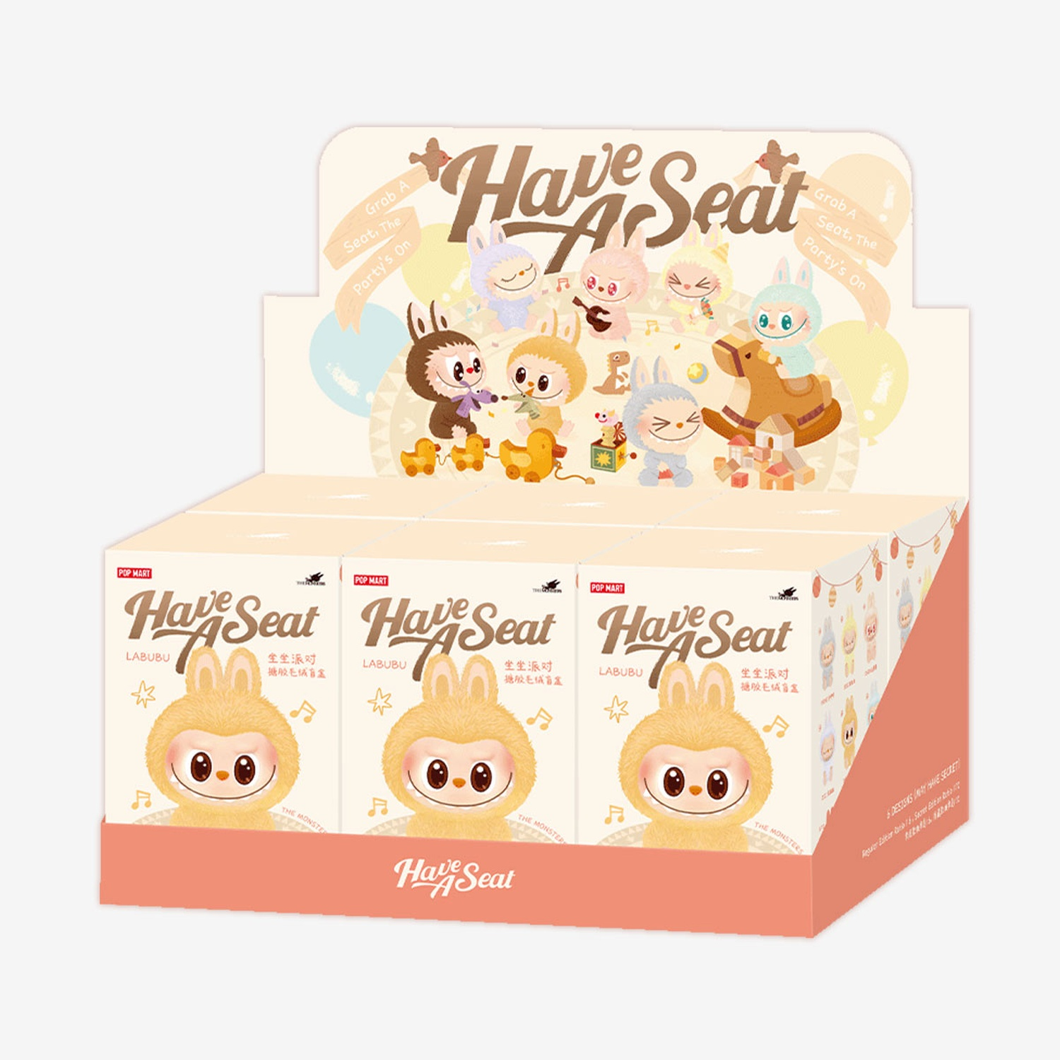 Una scatola espositiva con figure LABUBU, la scatola presenta personaggi dei cartoni animati di diversi colori. La frase "Have A Seat" è scritta sulla scatola.