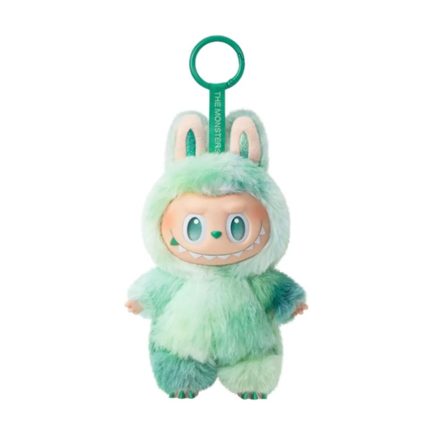 Un peluche mostro verde con orecchie da coniglio e portachiavi. Ha una faccia sorridente e indossa una tuta soffice.