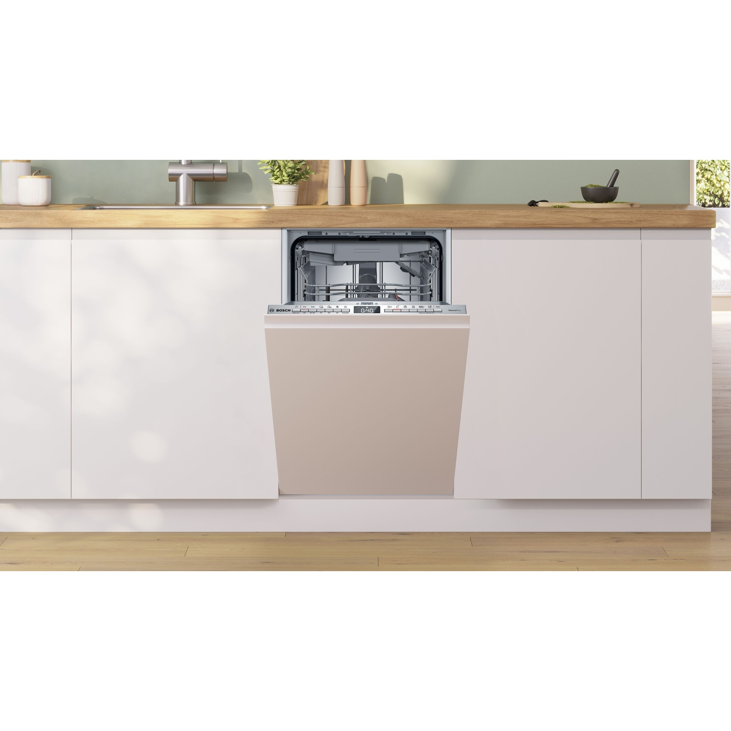 Una lavastoviglie a incasso con la porta aperta. La porta è beige, l'interno è grigio. Piano di lavoro della cucina con accessori e lavello sopra.