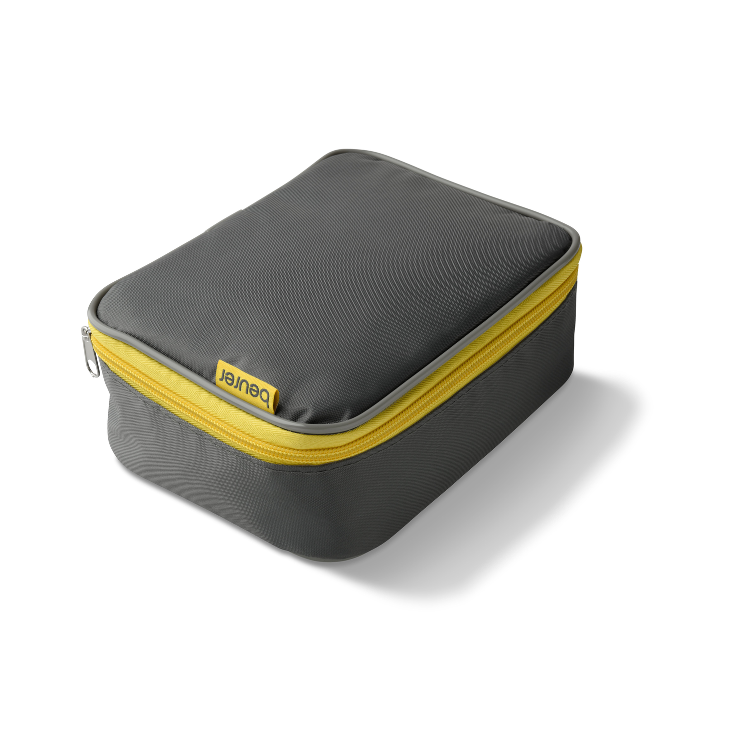 A gray rectangular case with a yellow zipper and the brand 'beurer' on it. The case casts a shadow on a white surface.