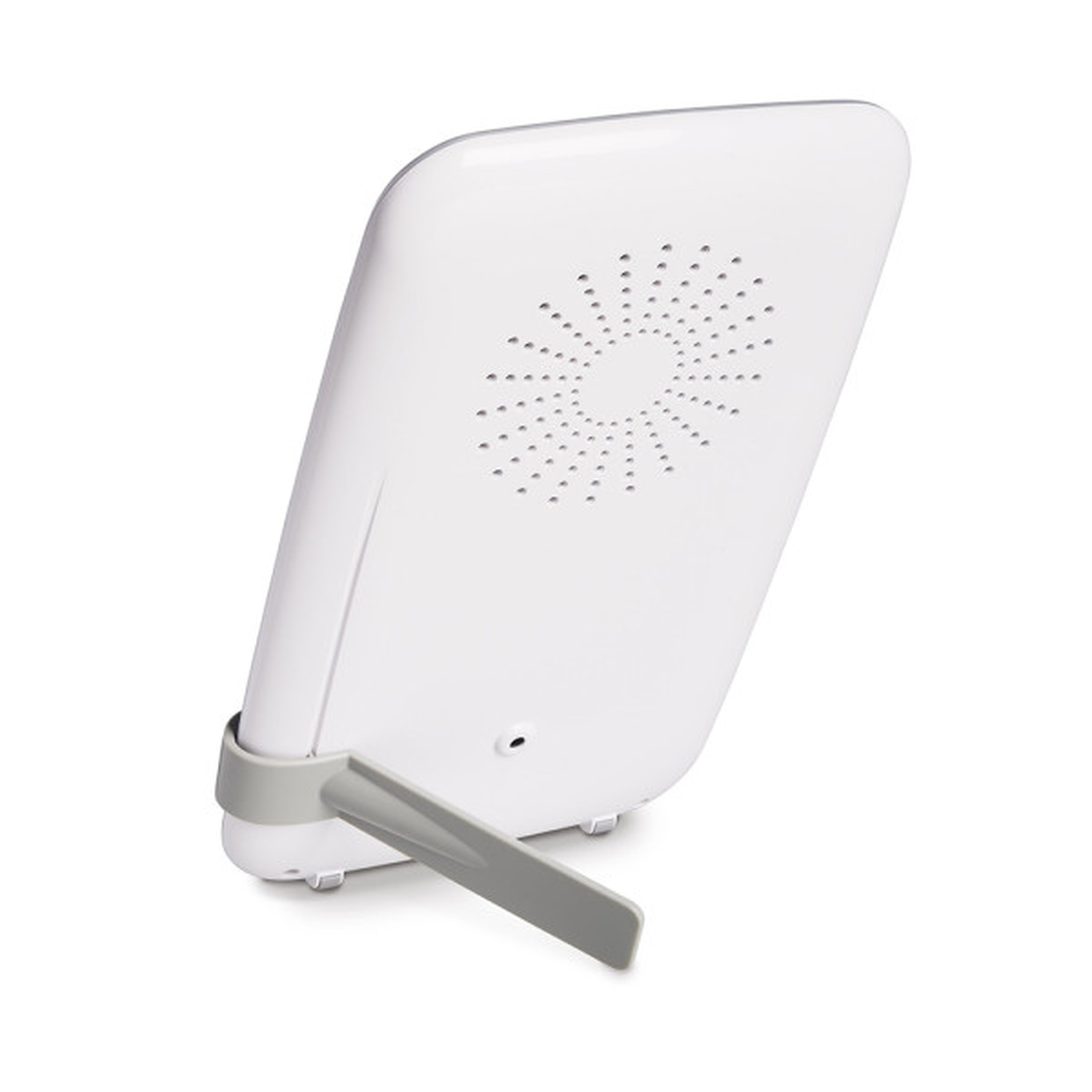 A white device with a gray stand. It has a speaker-like design on the back. The stand is angled, suggesting a tilted view.