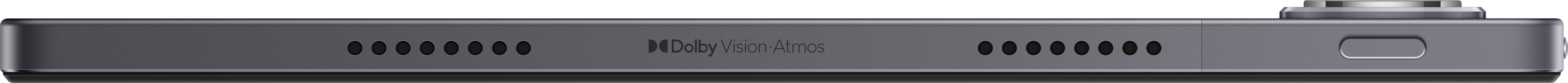 Zbliżenie boku szarego urządzenia. Posiada otwory głośnikowe, port ładowania i markę Dolby Vision Atmos.