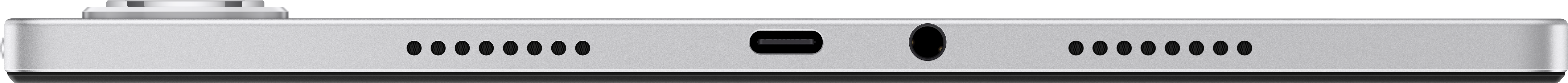 Spód srebrnego urządzenia z otworami głośnikowymi, portem USB i gniazdem słuchawkowym na czarnym tle.