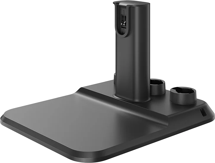 Eine schwarze Ladestation für einen Staubsauger. Sie hat eine rechteckige Basis, einen vertikalen Ladeanschluss und zwei kreisförmige Zubehörhalter.