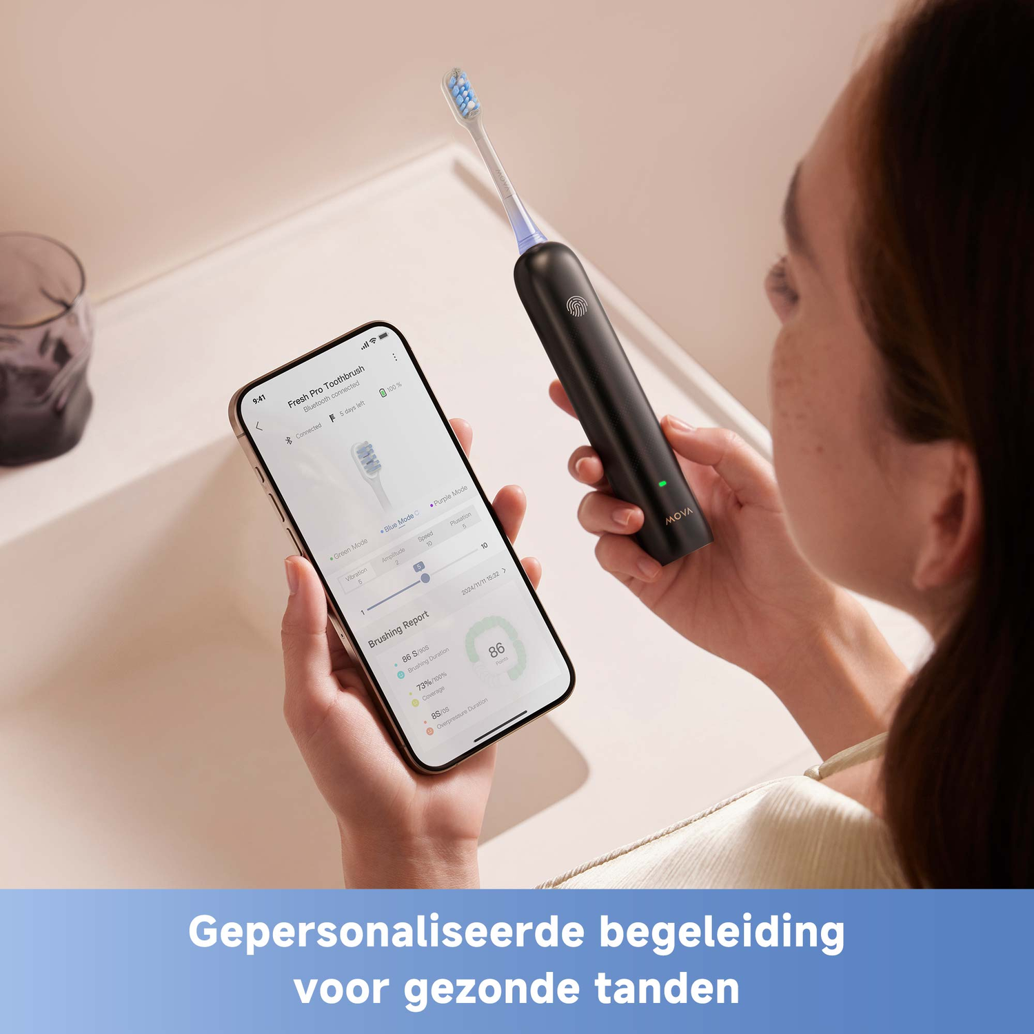A woman holds a phone displaying brushing data and a black toothbrush. The toothbrush is held up near the phone.