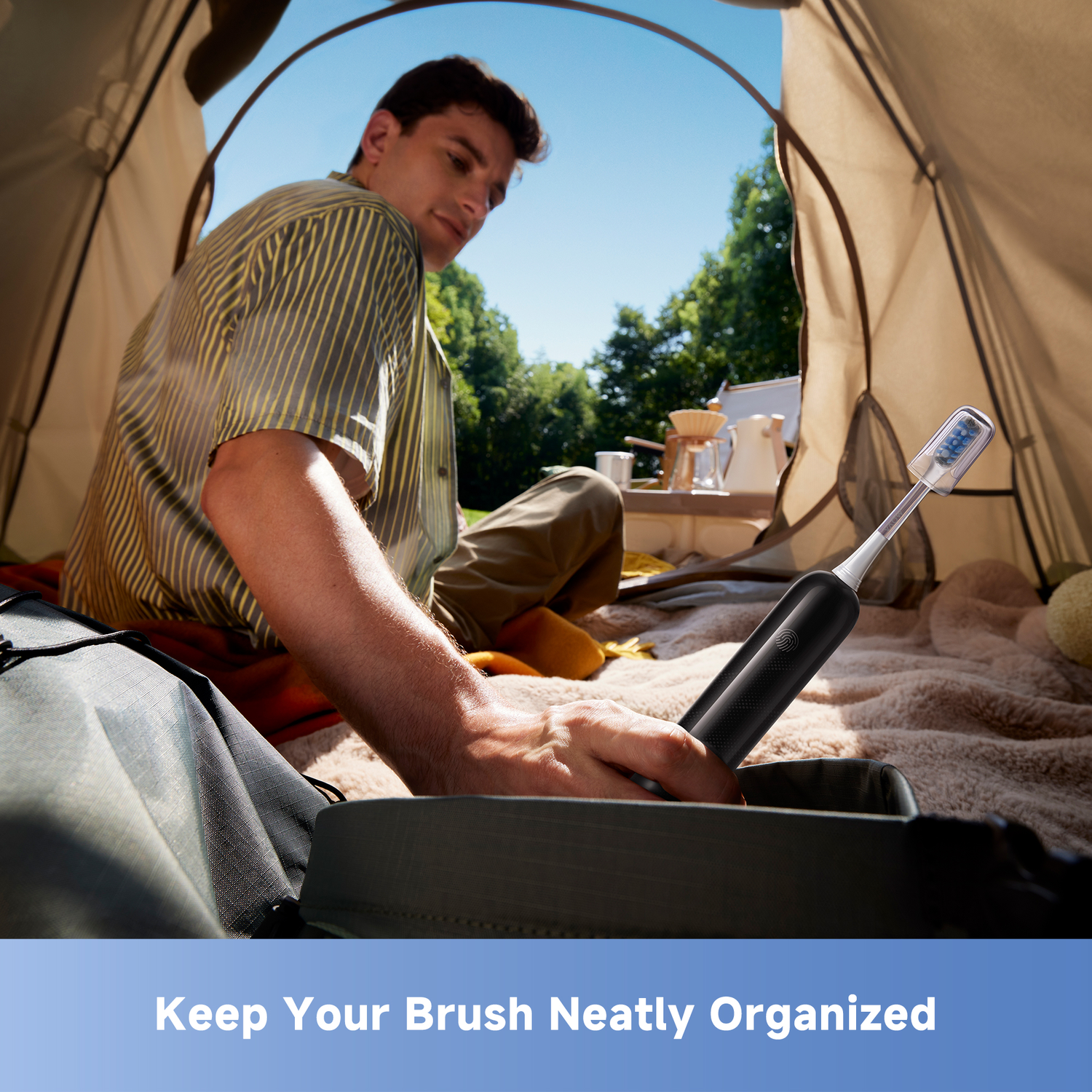 Man in tent holding a toothbrush. Background shows camping gear and trees. The text at the bottom says 'Keep Your Brush Neatly Organized'.