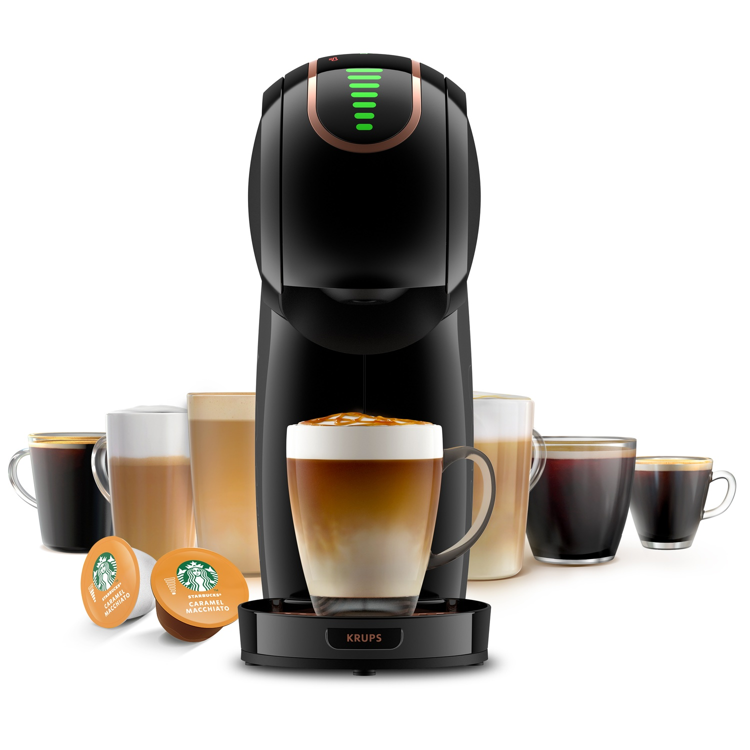 Zwart koffiezetapparaat met kopjes koffie en caramel macchiato. Twee Starbucks capsules vooraan.