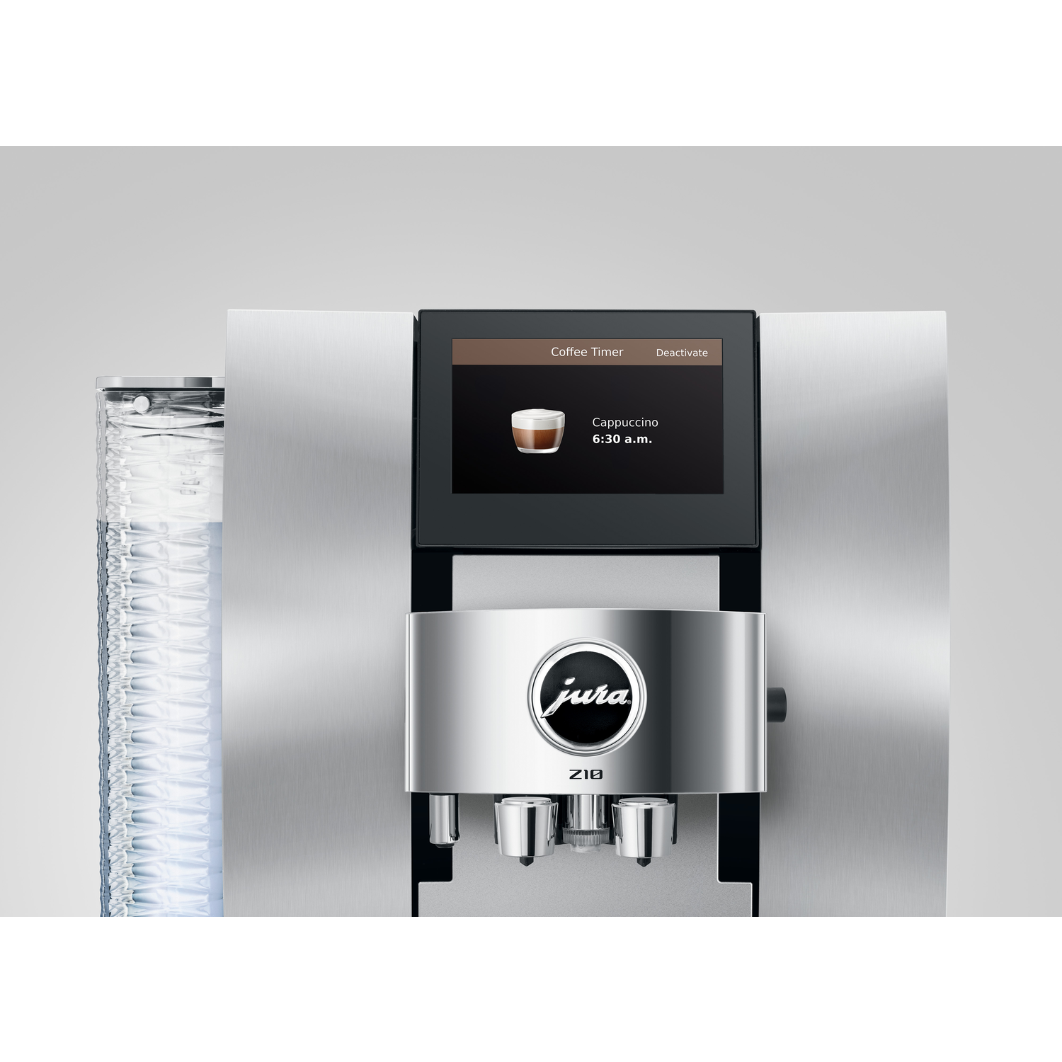 A silver Jura Z10 coffee machine. It displays a cappuccino icon and the time. The machine has a water container on the left.