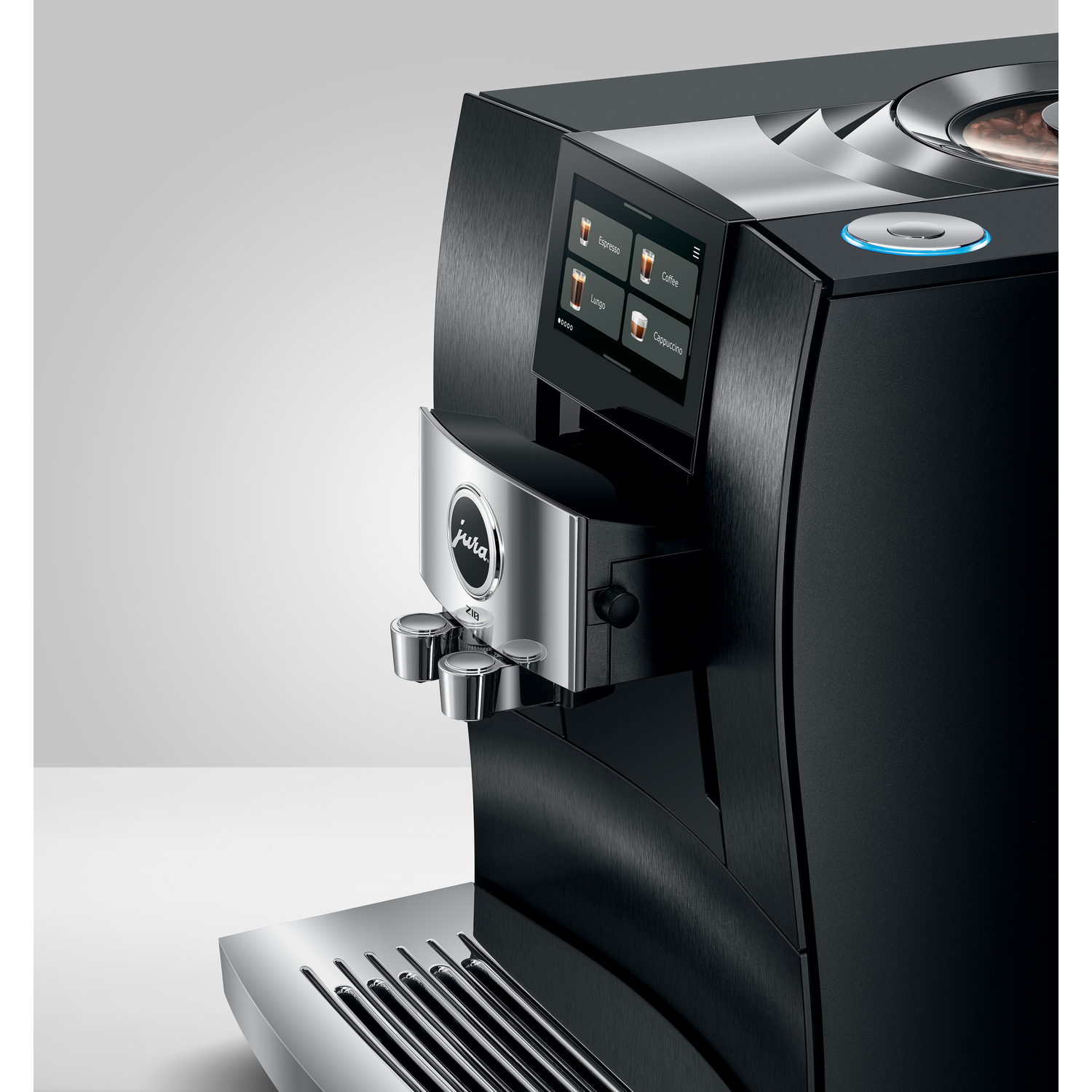 A black and silver Jura coffee machine with a touchscreen displaying coffee options. A blue light shines on top.