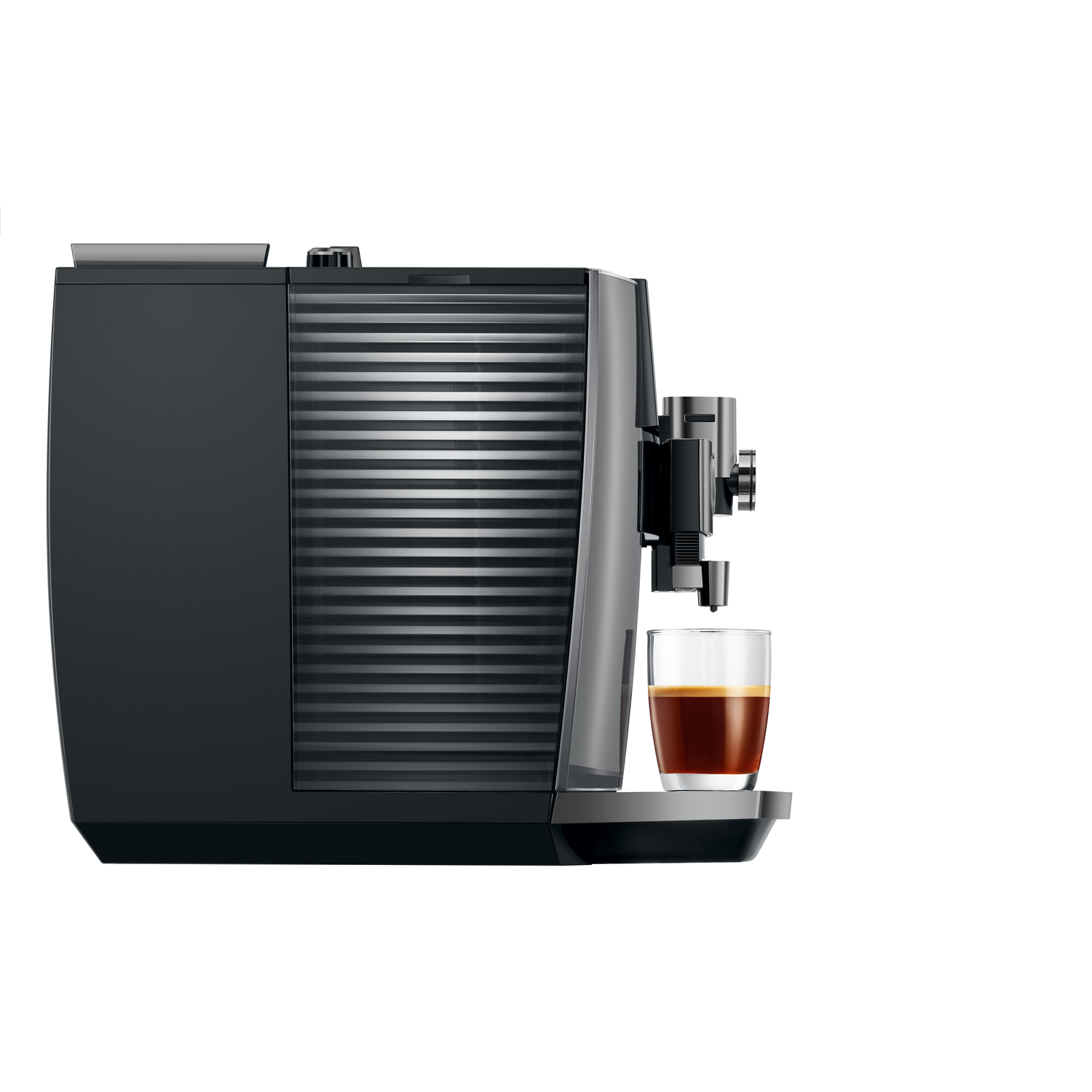 A black espresso machine with a glass of coffee. The machine has a ribbed design and a sleek, modern look. The coffee is dark.