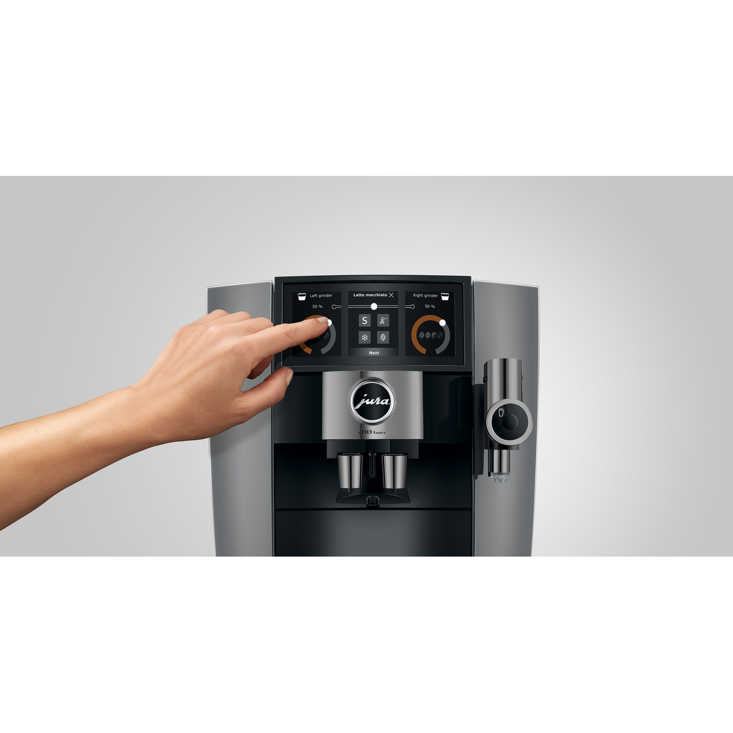 A hand touches a coffee machine screen. The machine is gray and black, with a logo that says 'jura'. The screen displays settings.