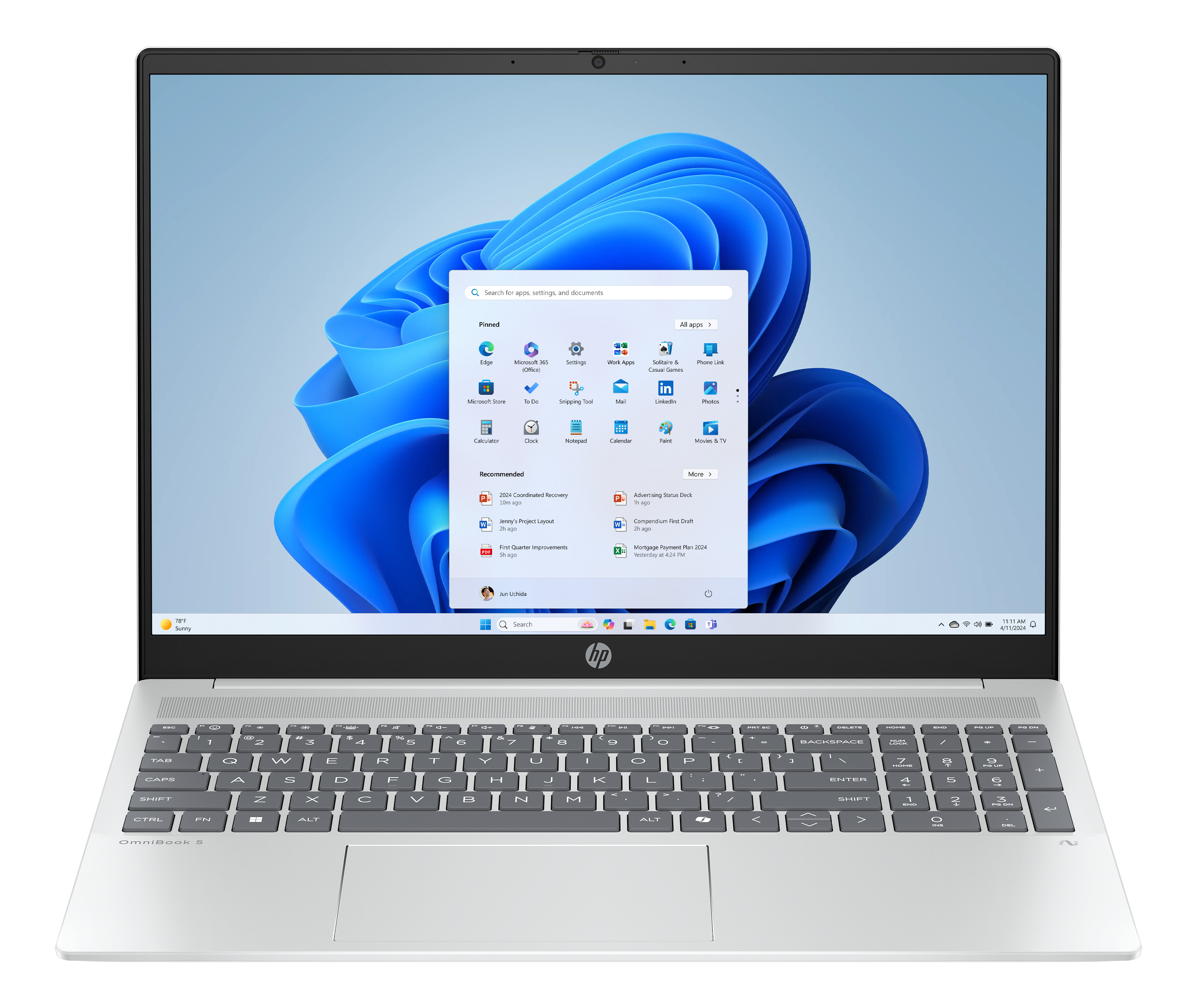 Ein Laptop mit Windows 11-Oberfläche ist geöffnet und zeigt App-Symbole und einen blauen Hintergrund.