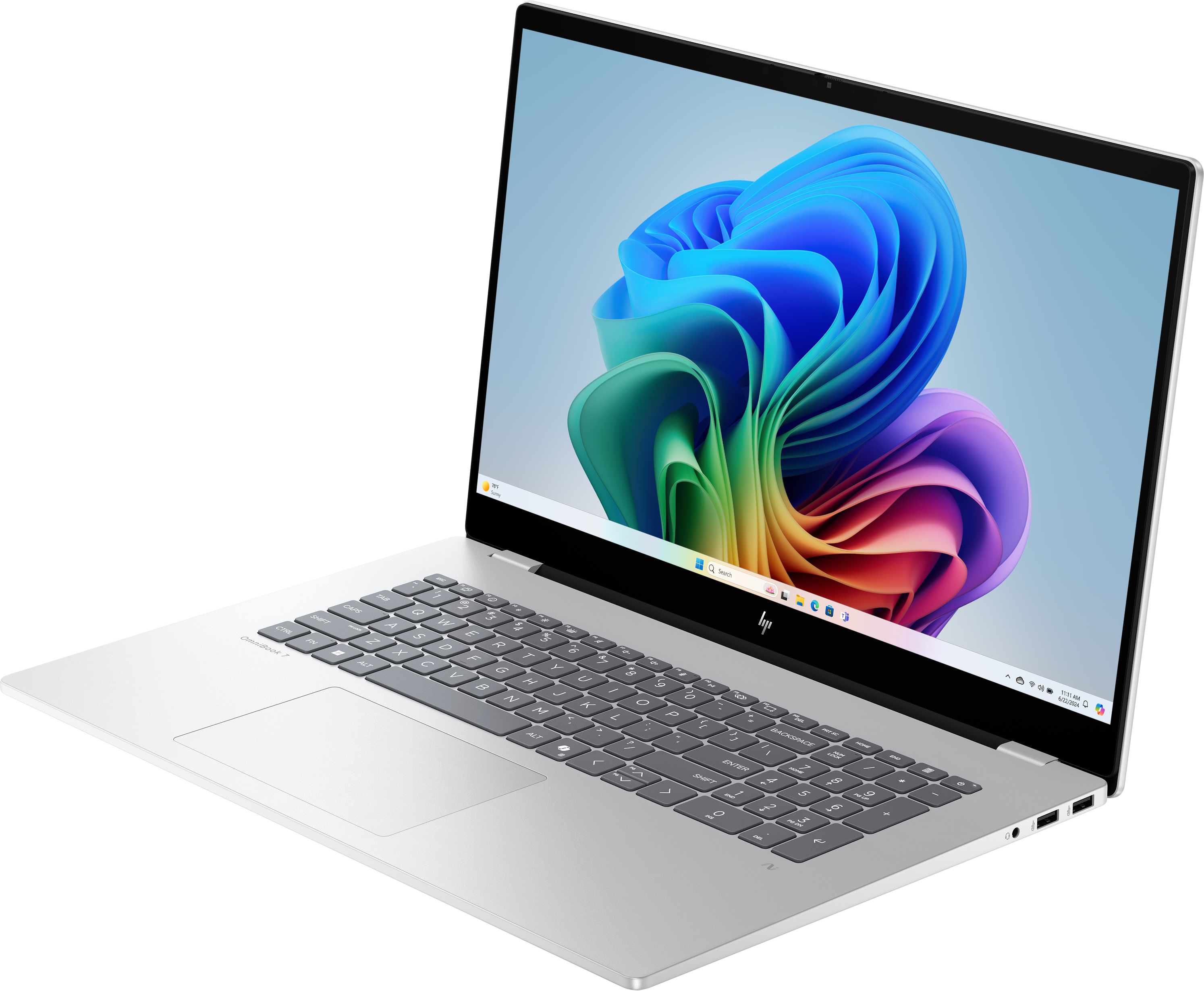 Laptop argentato mostra una grafica a spirale colorata. Tastiera visibile. Sfondo nero.
