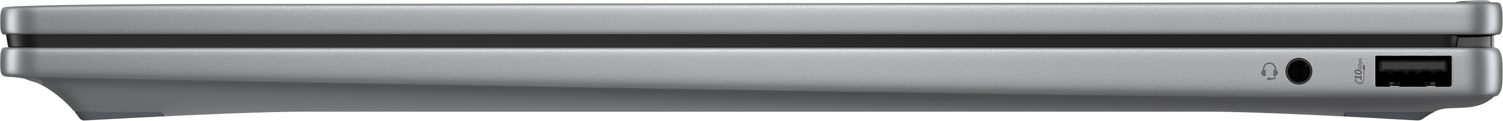 Ein silbernes Gerät, möglicherweise ein Laptop, von der Seite betrachtet. Zu den Merkmalen gehören eine Kopfhörerbuchse und ein USB-Anschluss.