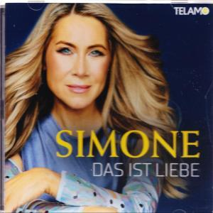 Simone, mit blonden Haaren, blickt nach vorne. Sie trägt ein blaues Oberteil.