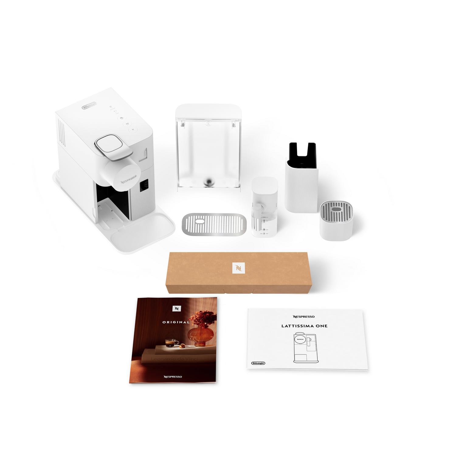 Una cafetera Nespresso Lattissima One blanca con accesorios y manuales, dispuesta sobre una superficie blanca.