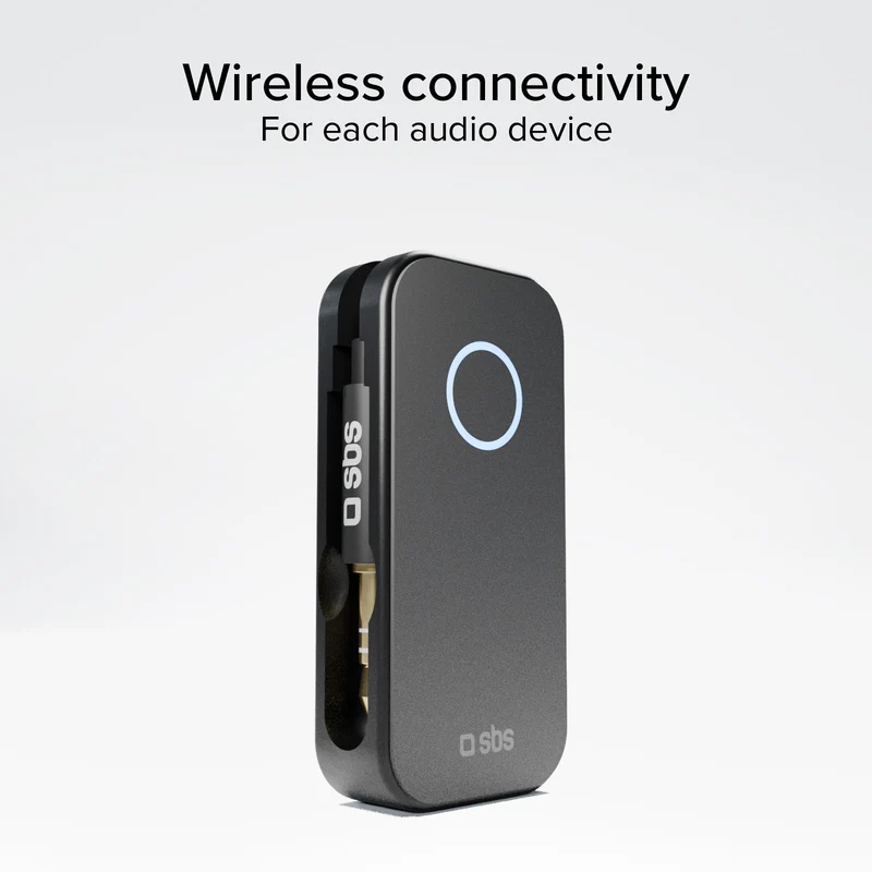 Ein schwarzes Gerät zur drahtlosen Konnektivität mit einem leuchtenden Kreisk button. Ein Audiokabel mit "sbs" ist eingesteckt.