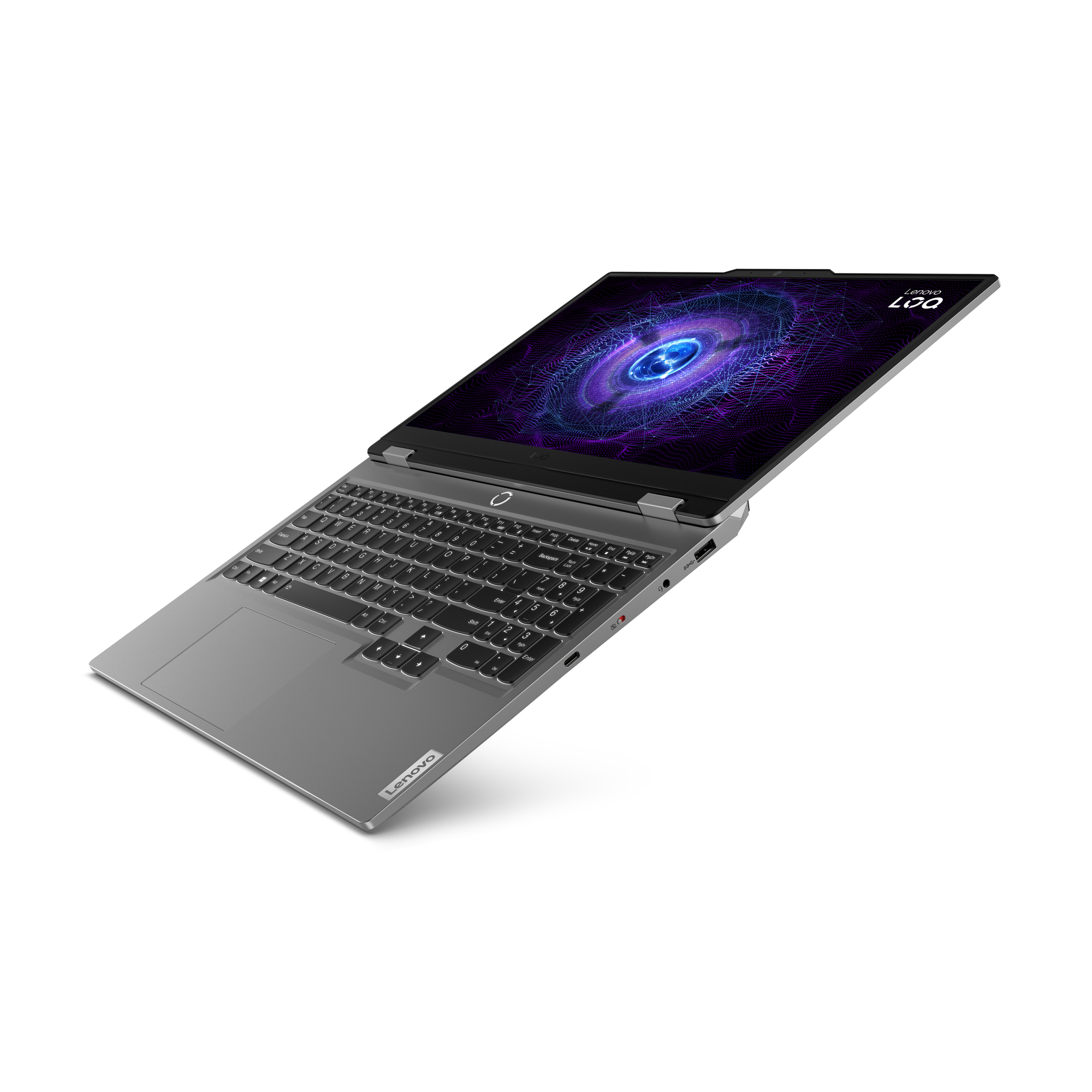 Una laptop Lenovo plateada está abierta, mostrando un diseño digital colorido. El teclado es visible.