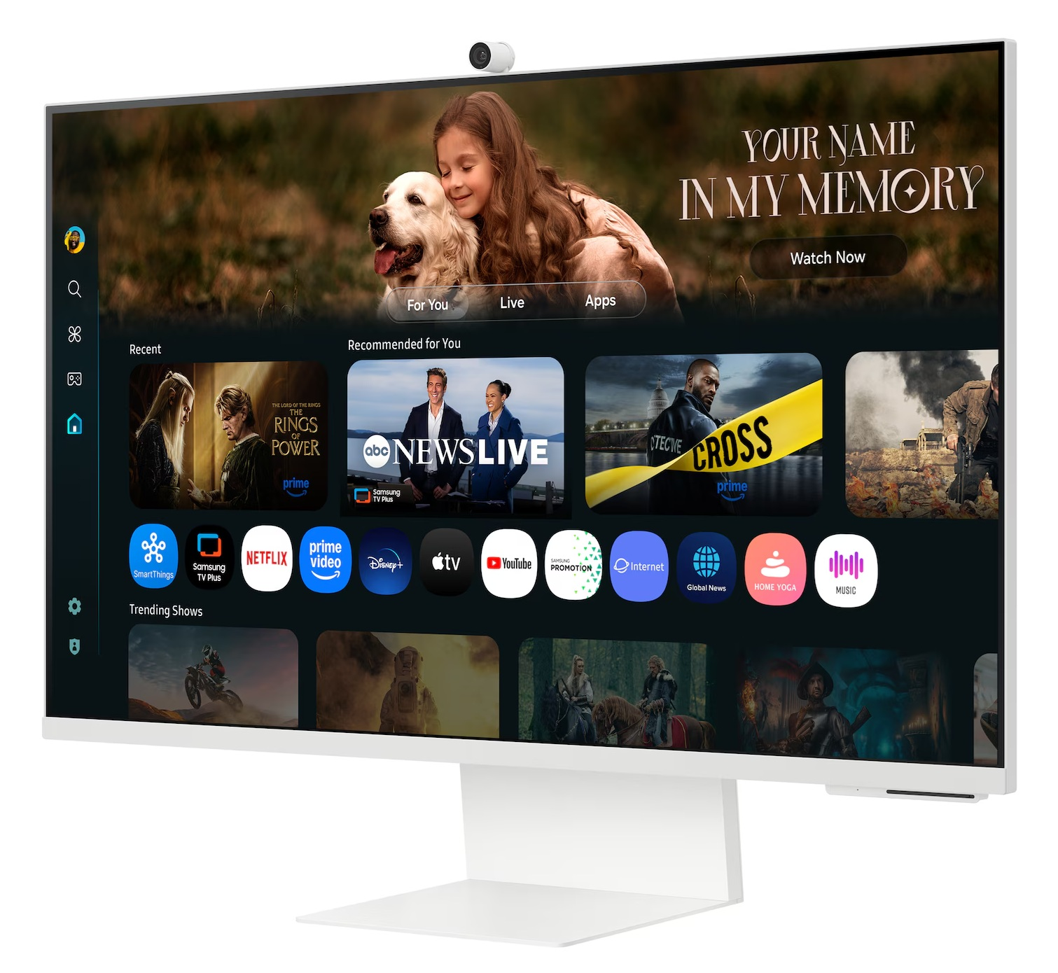 Biały monitor wyświetla scenę filmową z dziewczynką i psem. Ikony aplikacji i usług streamingowych są widoczne. Monitor ma kamerę.