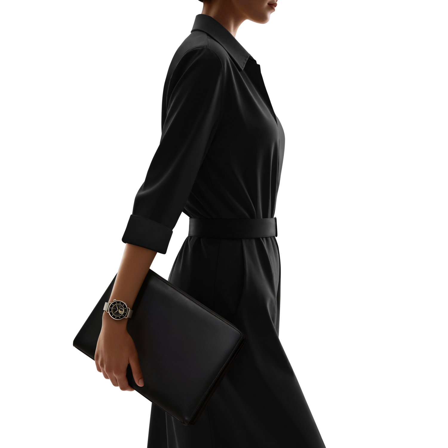 A person in a black dress walks, holding a black folder, and wearing a watch. The background is black.