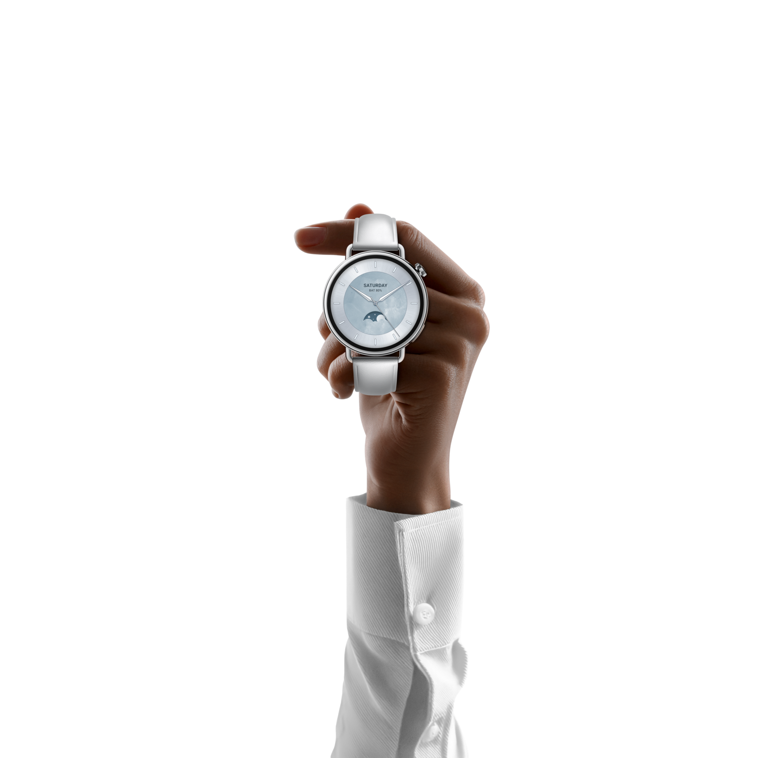A hand holding a white watch with a light blue face and white band, wearing a white shirt against a black background.