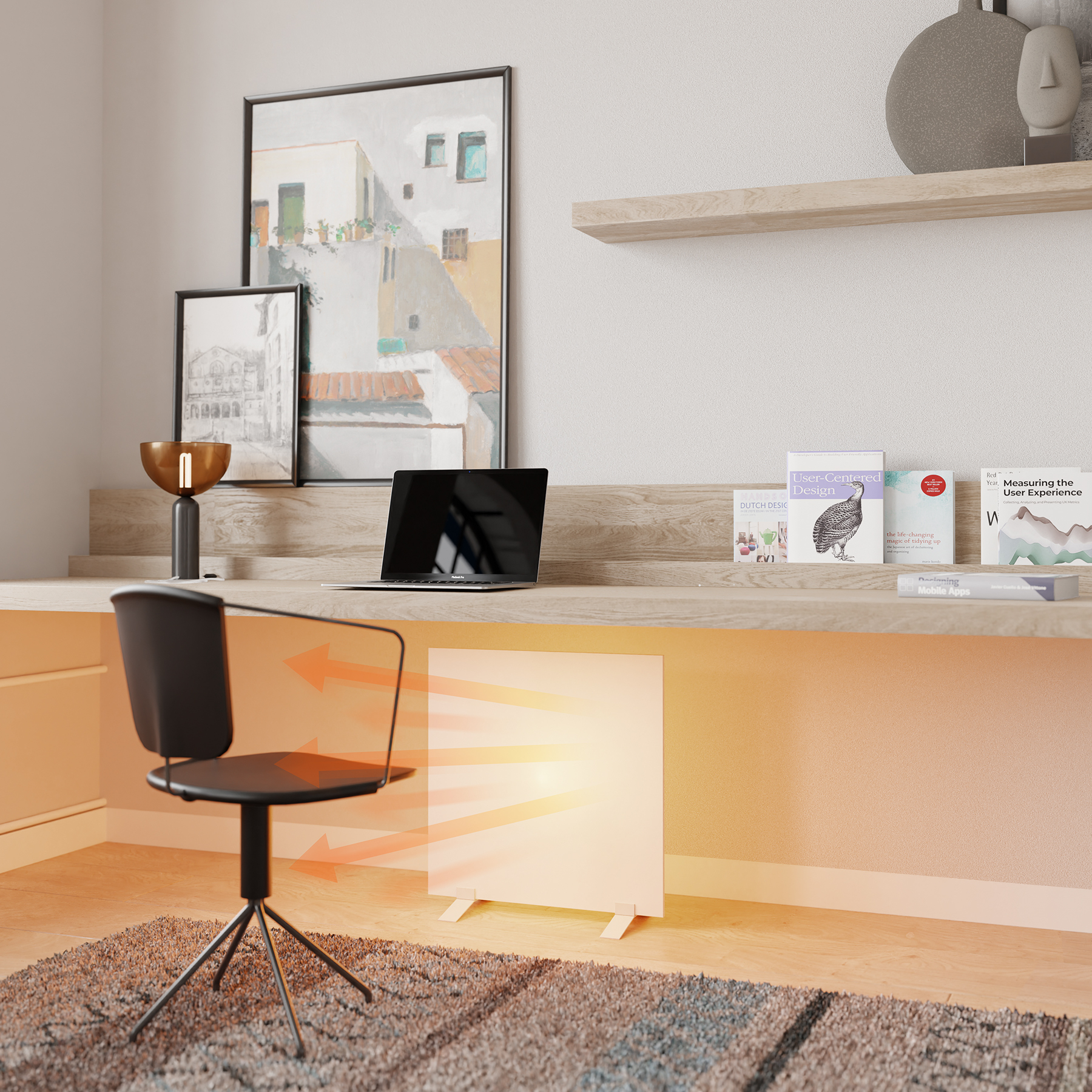 Ein modernes Büro. Ein Laptop steht auf einem Schreibtisch mit Büchern. Ein Heizgerät im Vordergrund und Kunst an der Wand.