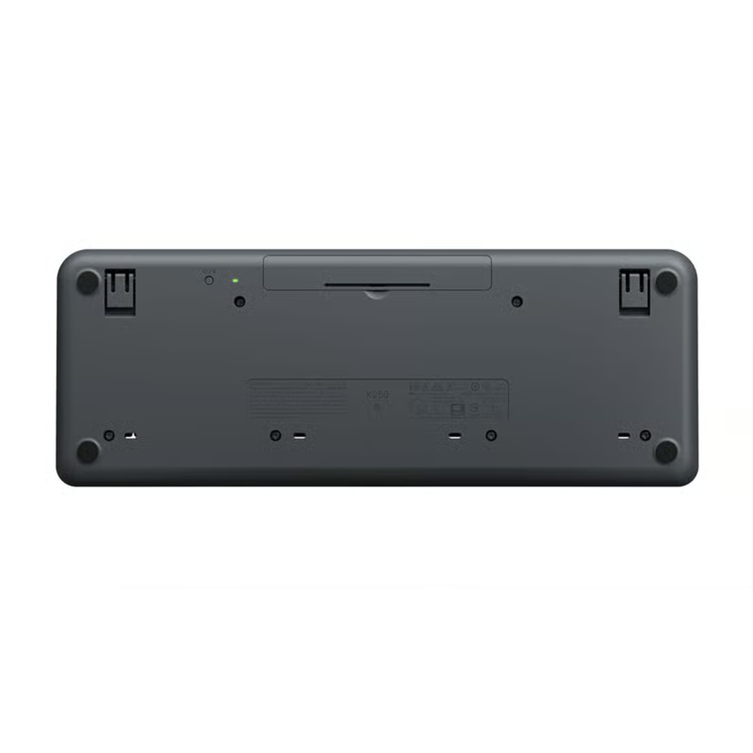 The underside of a gray wireless keyboard is shown. It has rubber feet, small lights, and a battery compartment. The brand is Logitech.