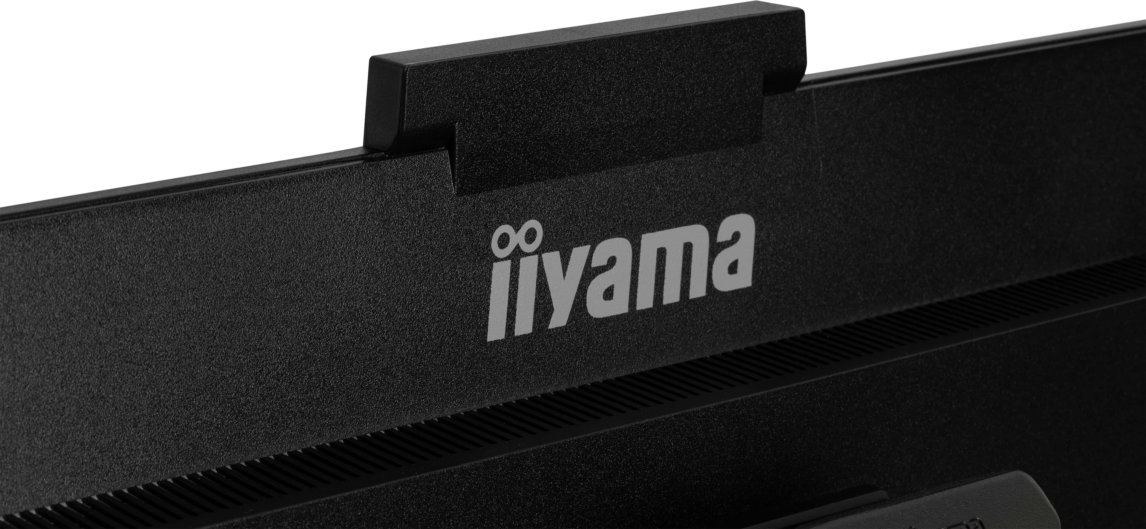 Nahaufnahme eines schwarzen Iiyama-Monitors. Das Logo ist sichtbar. Die Oberseite hat ein hervorstehendes Element. Die Oberfläche ist strukturiert.
