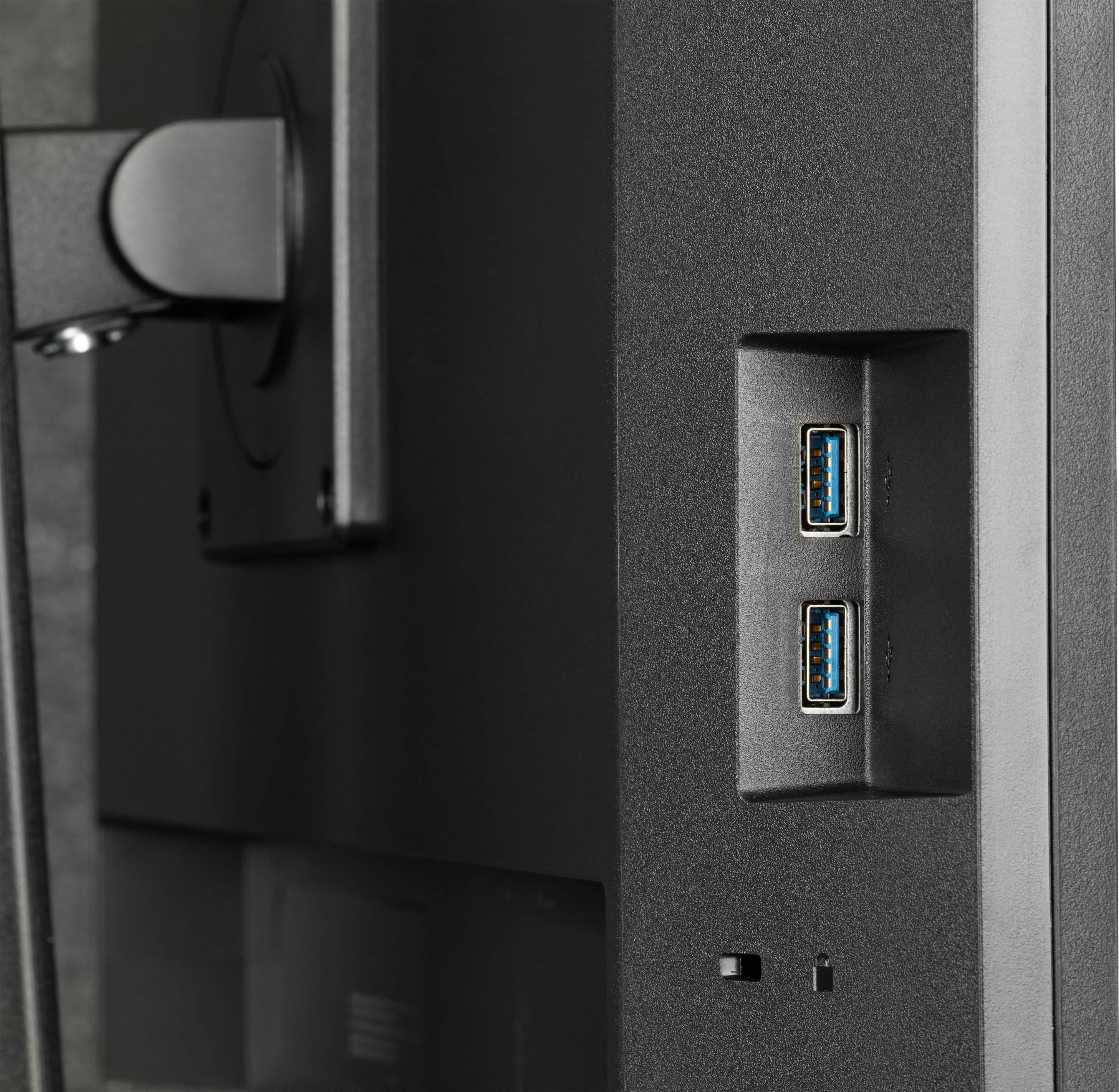Nahaufnahme der Rückseite eines Computermonitors. Zeigt zwei USB-Anschlüsse, einen Netzschalter und eine Halterung.