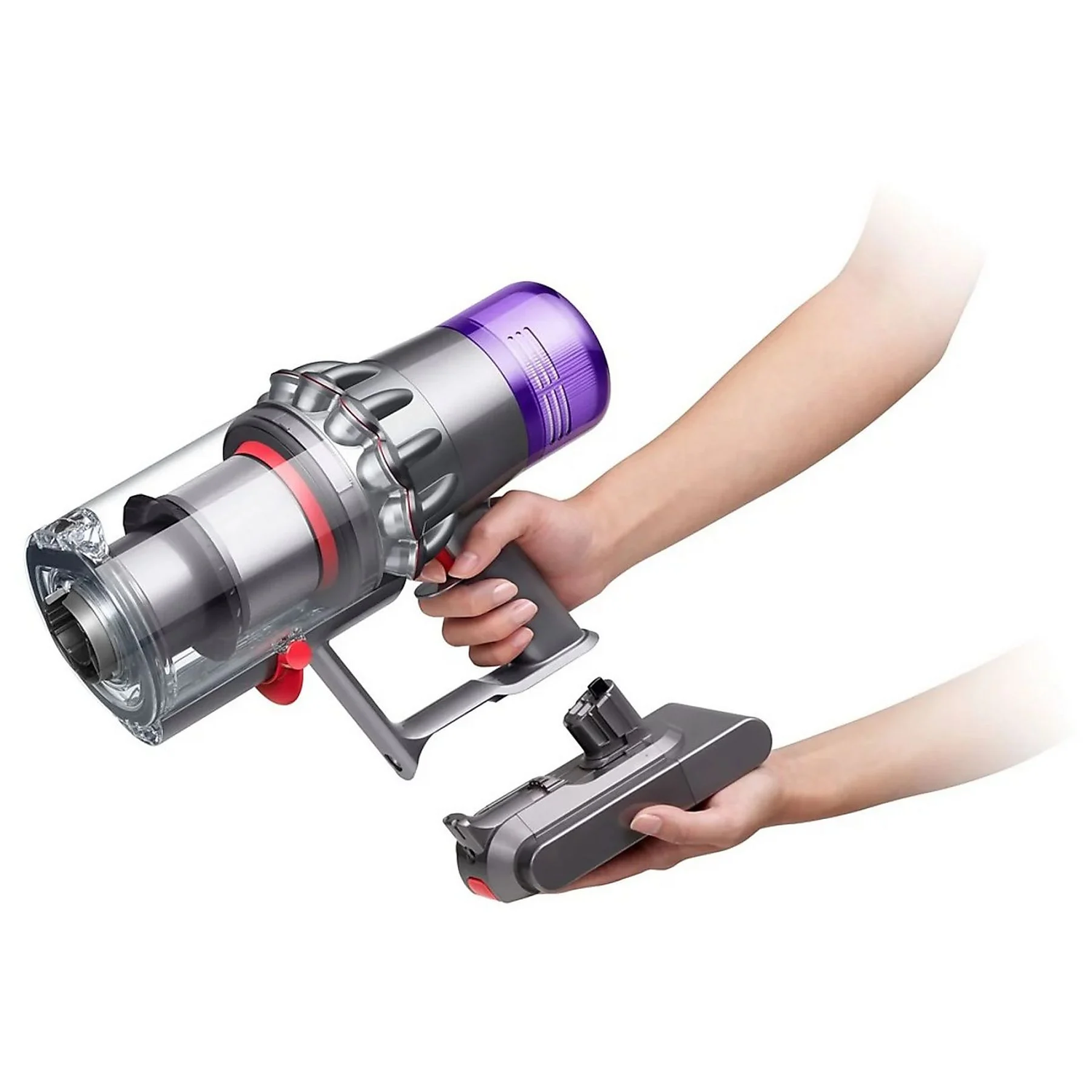 Hand holds a silver and purple Dyson vacuum cleaner with an attachment. The background is white.