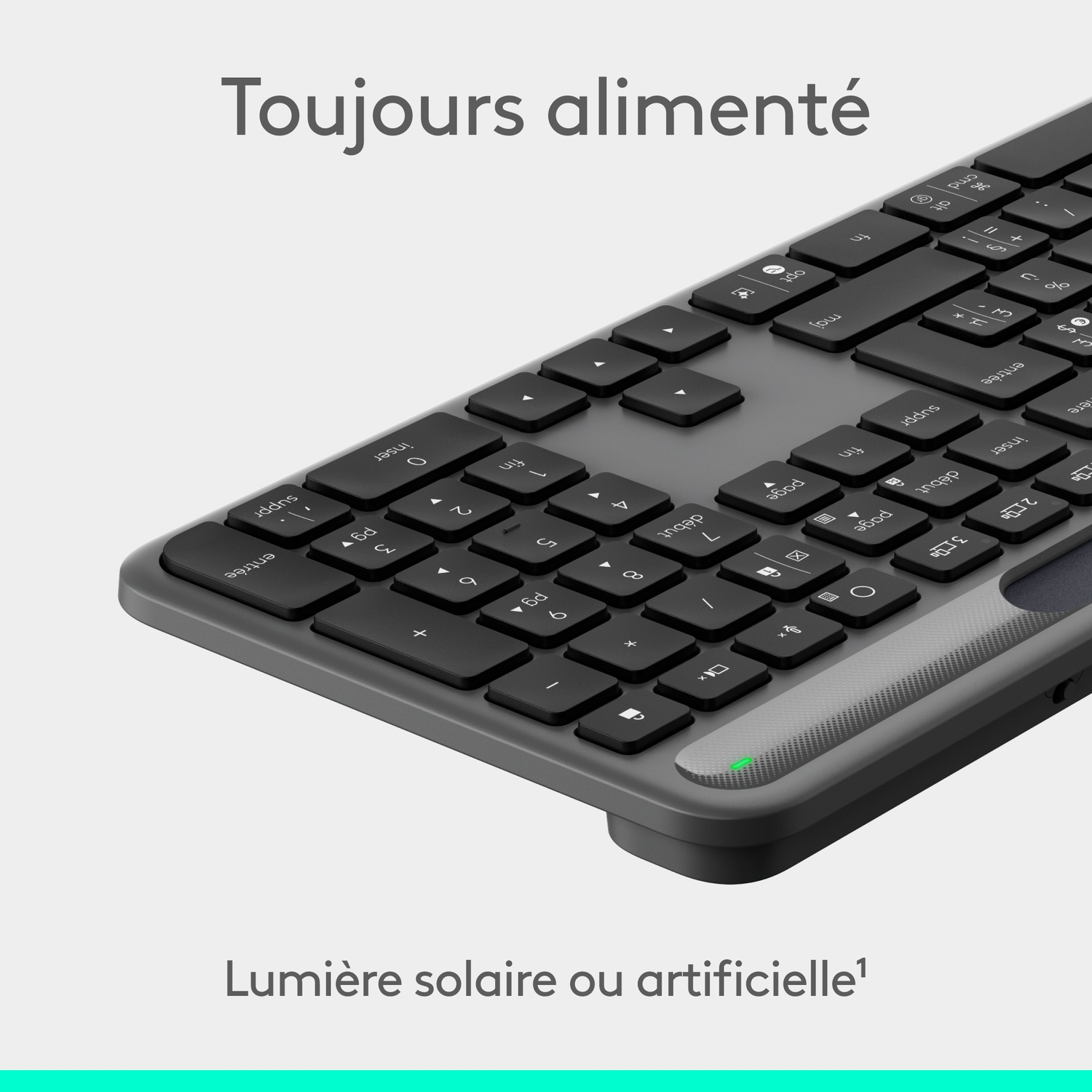 Un clavier gris avec des touches noires. Le texte indique 'Toujours alimenté' et 'Lumière solaire ou artificielle'.