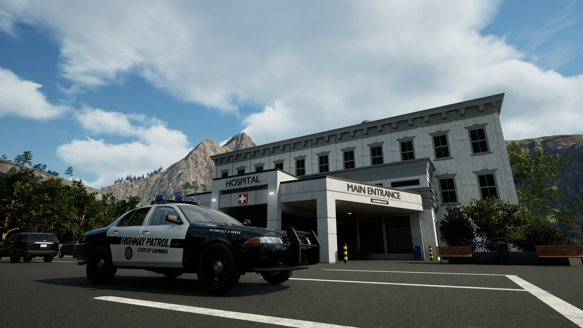 Une voiture de patrouille routière est devant un hôpital avec des montagnes et un ciel bleu en arrière-plan. L'entrée de l'hôpital est visible.